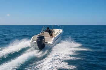 Sport boat with 180 hp outboard raising a lively wake